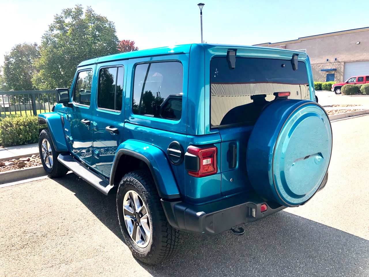 bright blue suv parked on a sunlit street