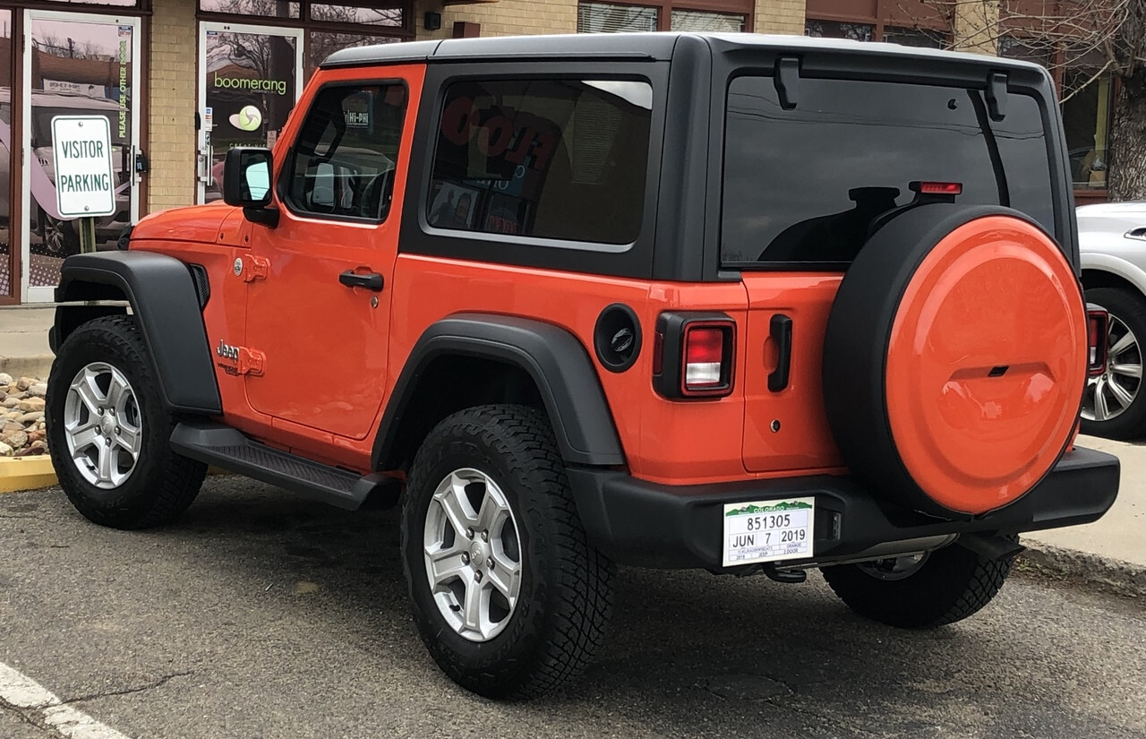 orange Jeep Wrangler with color-matched spare tire cover